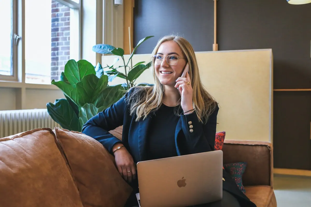 DyBilling account manager on the phone with a client at a laptop