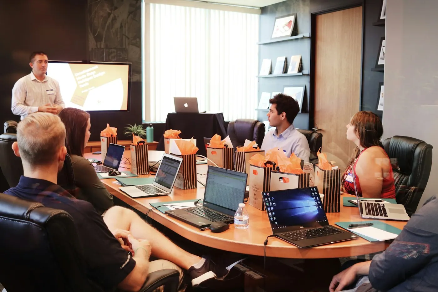 DyBilling billing team working at laptops around a conference table